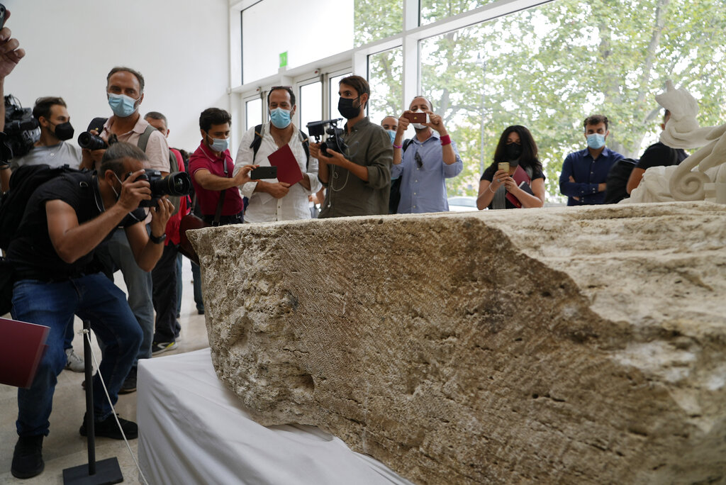 Photographers take pictures during the presentation to the press of an archeological finding emerged during the excavations at a Mausoleum in Rome