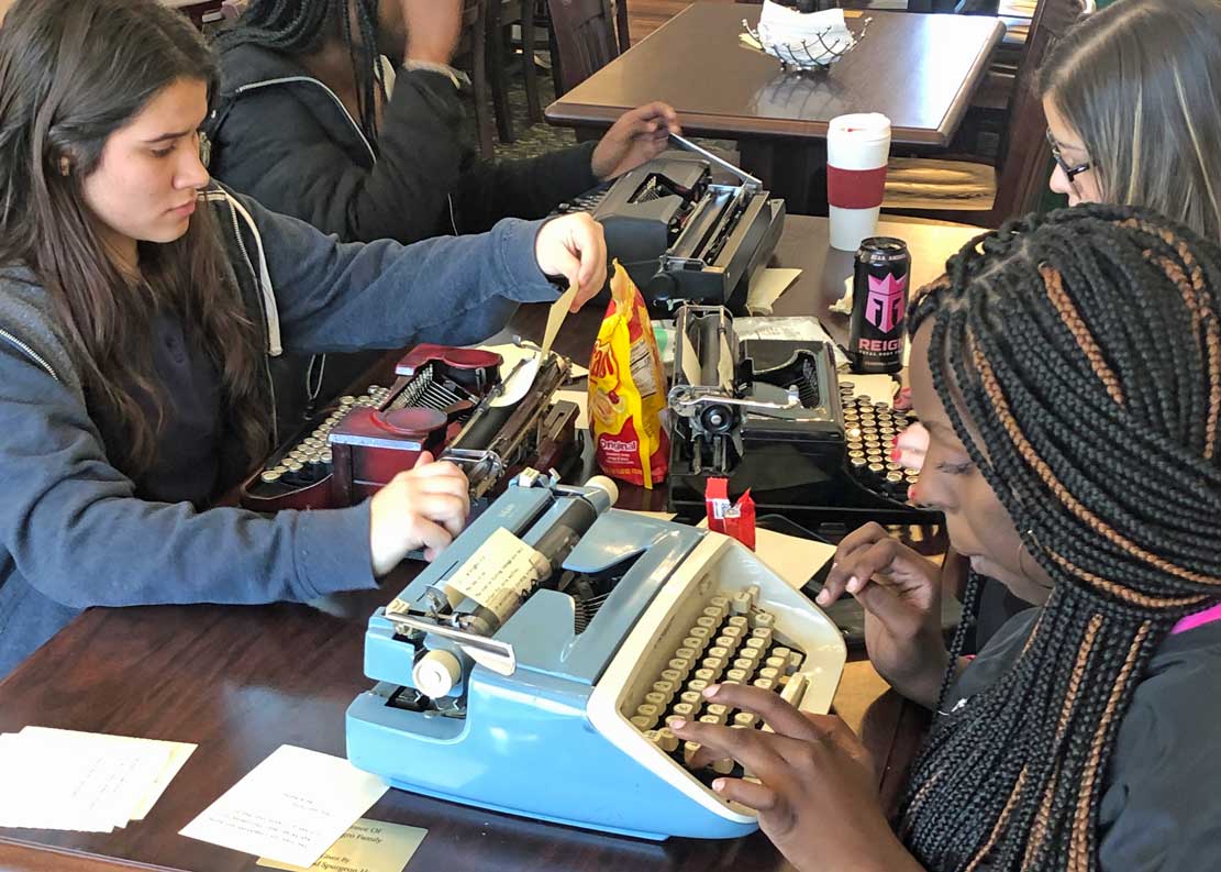 students using typewriters