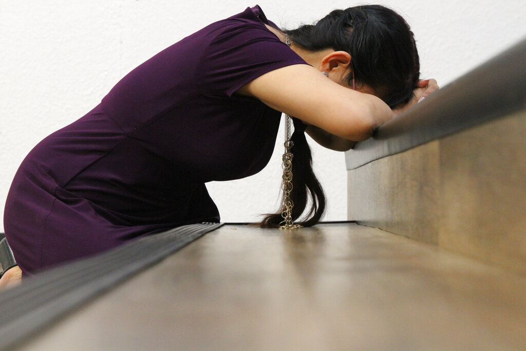 Linda Dunegan prays in the Open Door Baptist Church in Anchorage