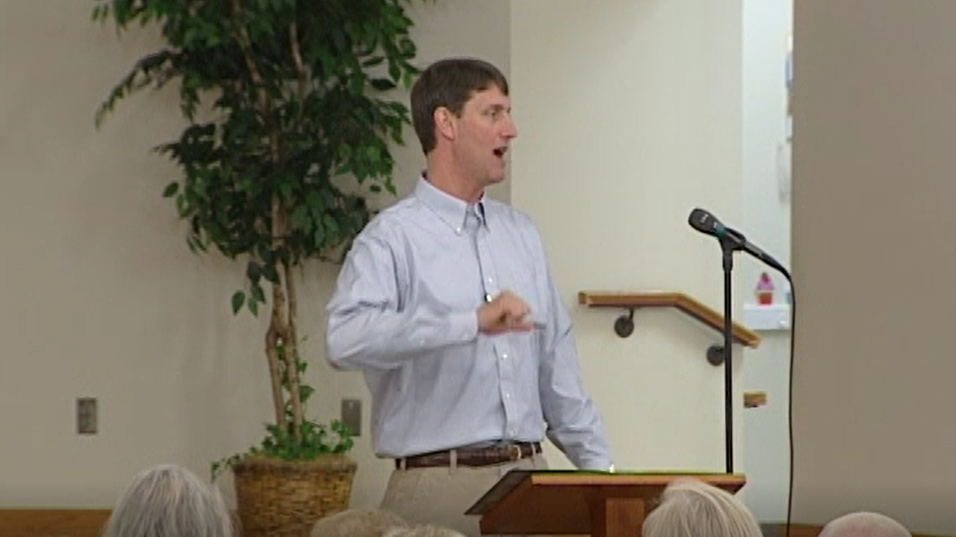 Man with light blue button-down shirt and khakis at podium