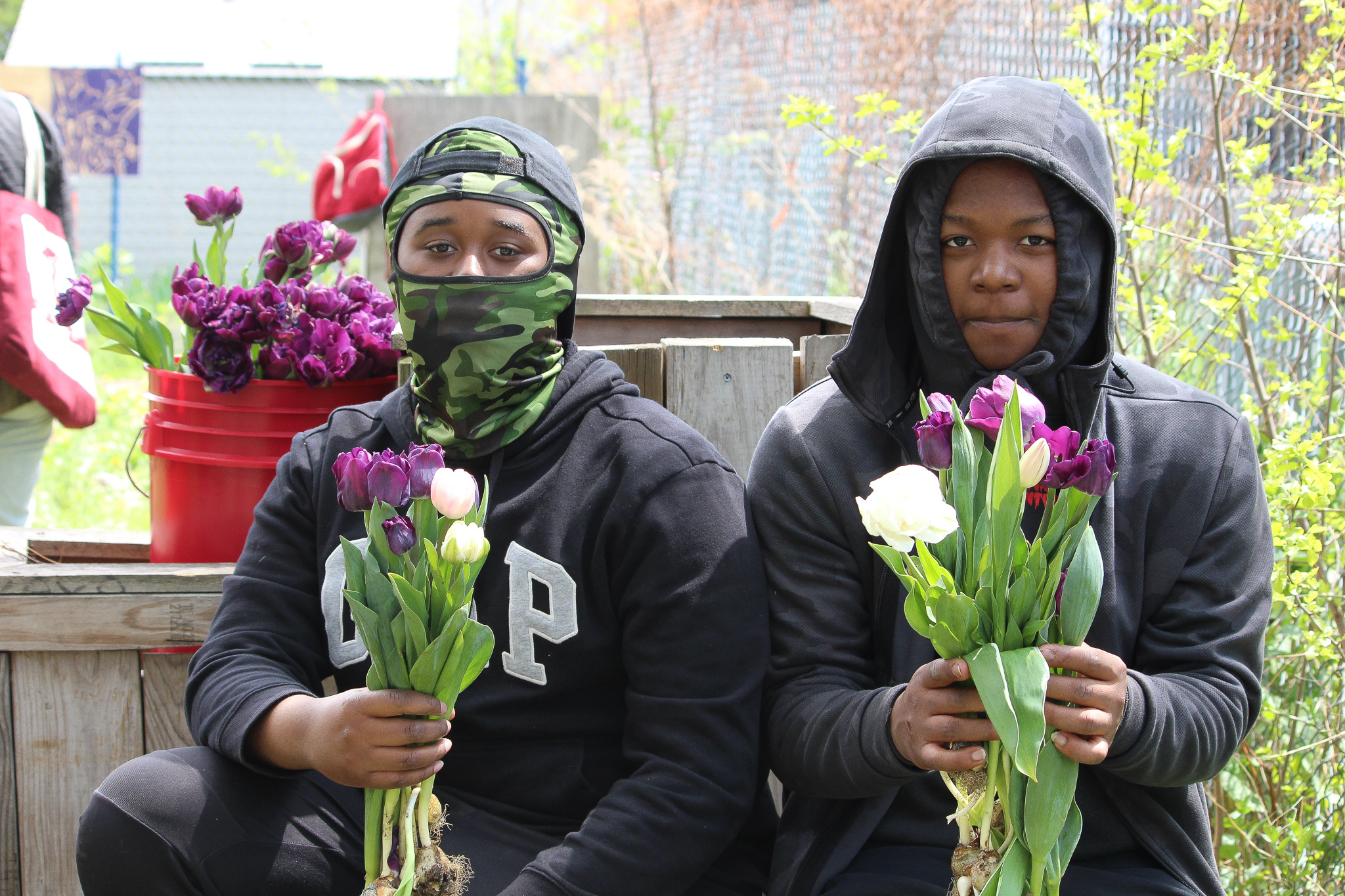 Young people holding flowers