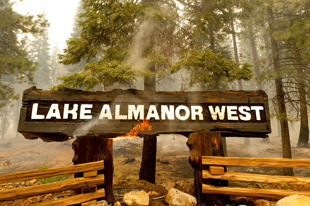 Flames burning sign at Dixie Fire