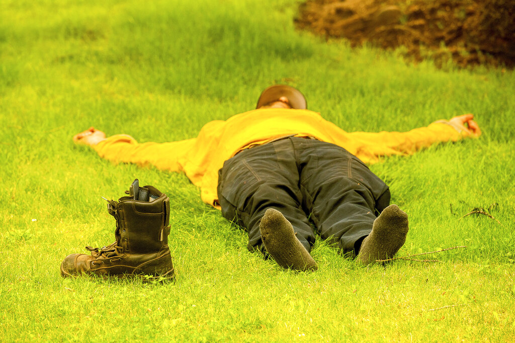 Healdsburg firefighter Justin Potter rests as his crew prepares to battle the Dixie Fire