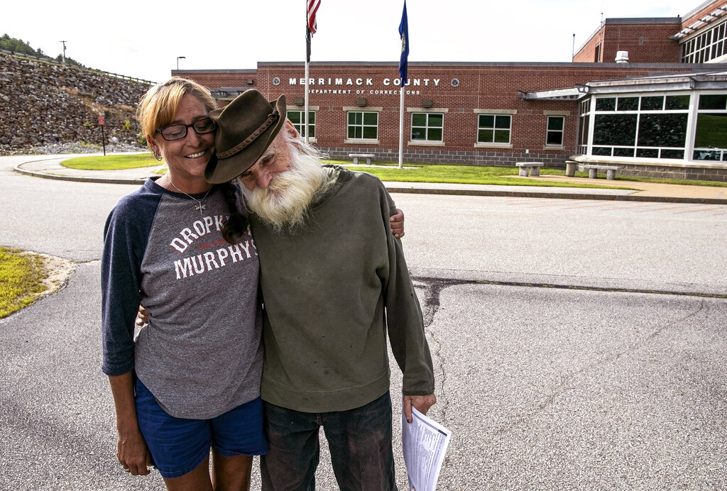 Jodie Gedeon, left, hugs David Lidstone, 81, right, Thursday, Aug. 5, 2021, after Lidstone was released from Merrimack County Jail, in Boscawen, N.H.
