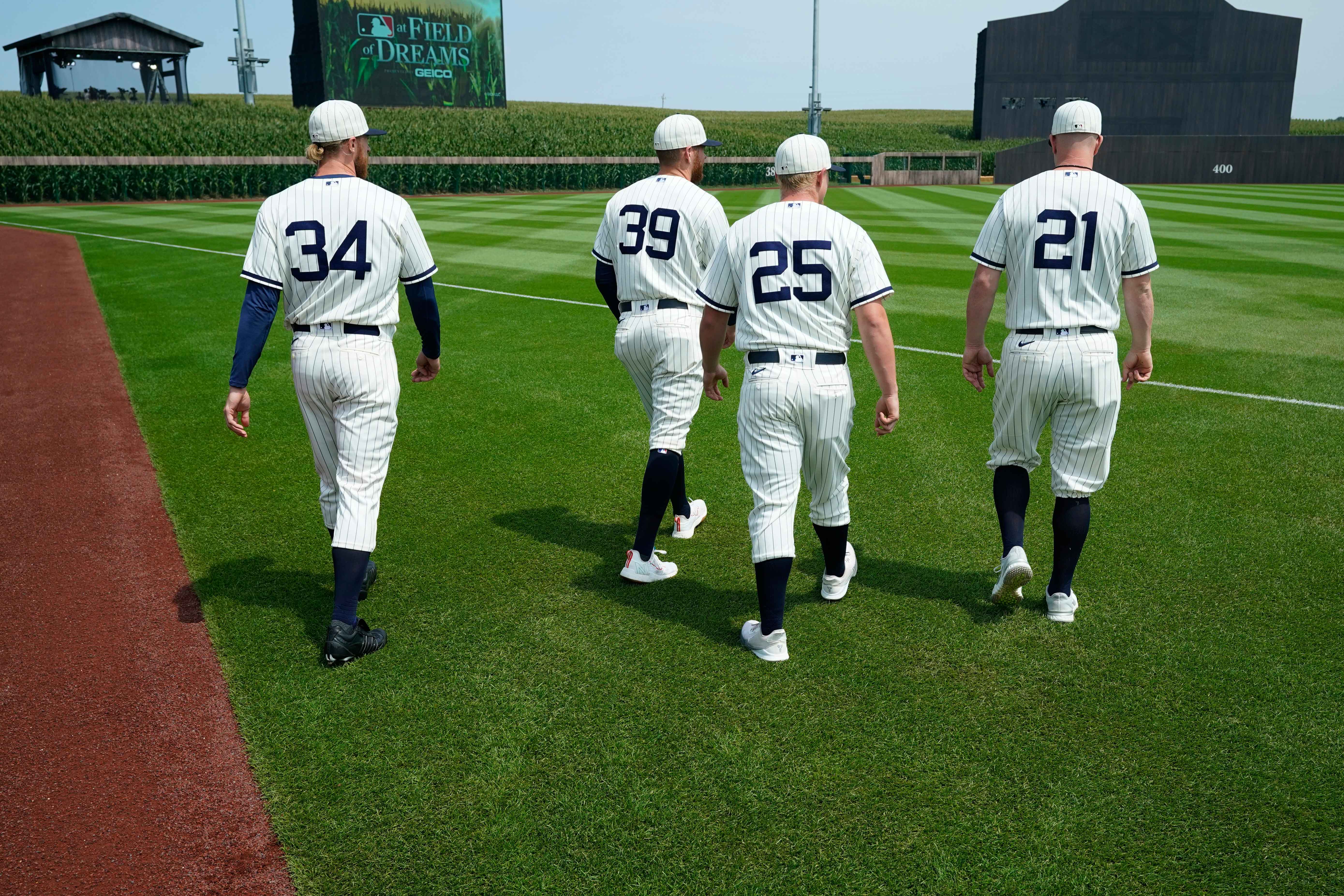players walk on the field before the "Field Of Dreams" game