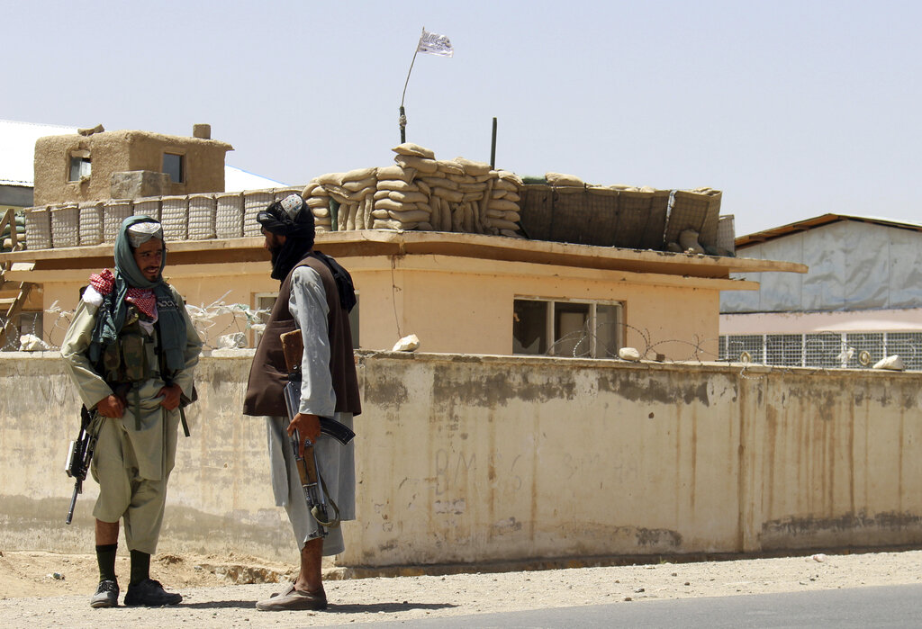 Taliban fighters stand guard inside the city of Ghazni, southwest of Kabul, Afghanistan