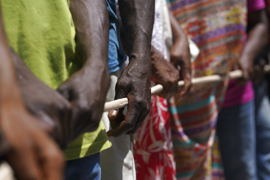 People line up for food aid in Camp Perrin, Haiti