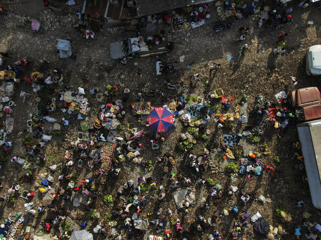 People gather on the first market day since the earthquake in Camp Perrin, Haiti