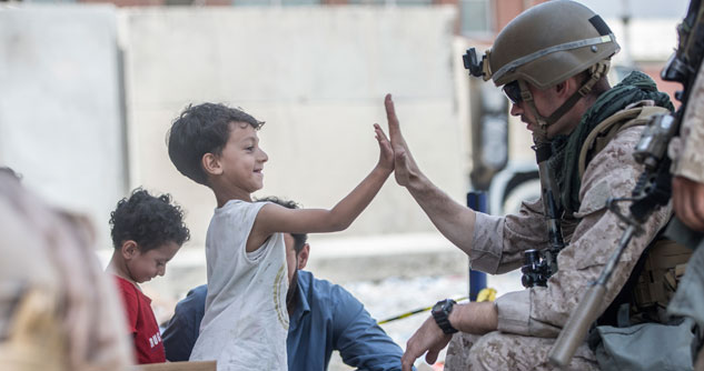 Soldier high-fiving child