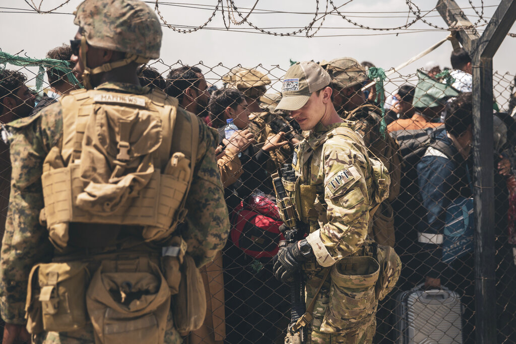 U.S. service members provide assistance during an evacuation at Hamid Karzai International Airport in Kabul