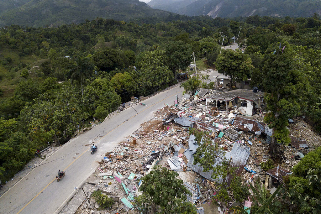 Homes lay in ruins along an earthquake-damaged road in Rampe, Haiti