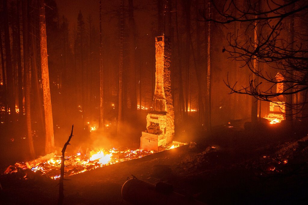 Seen in a long camera exposure, chimneys stand at residences leveled by the Caldor Fire along Highway 50