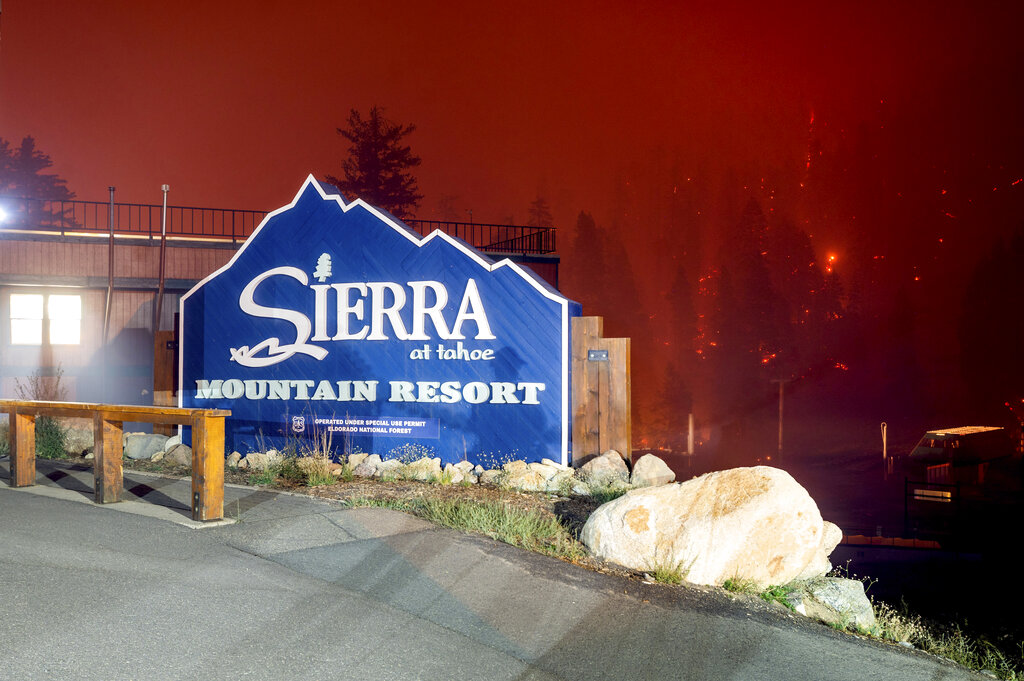Seen in a long camera exposure, the Caldor Fire burns at the Sierra-at-Tahoe ski resort