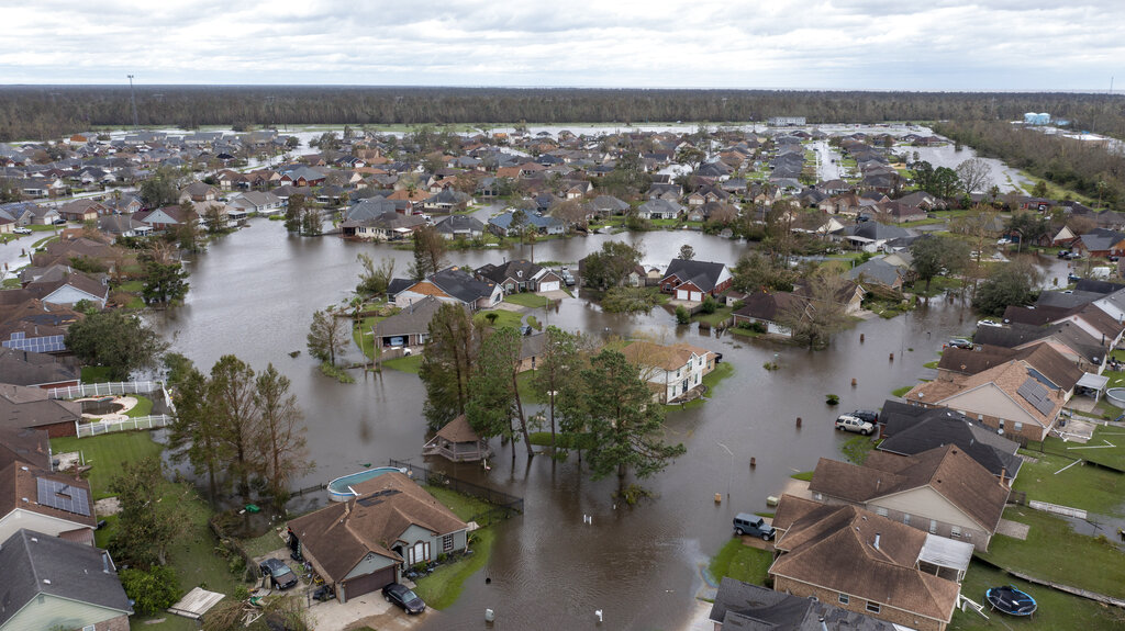 Flooded streets and homes are shown in the Spring Meadow subdivision in LaPlace, La.