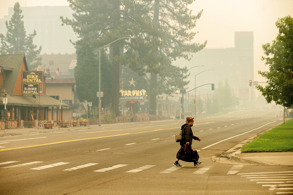 Person crosses roadway in South Lake Tahoe during Caldor Fire