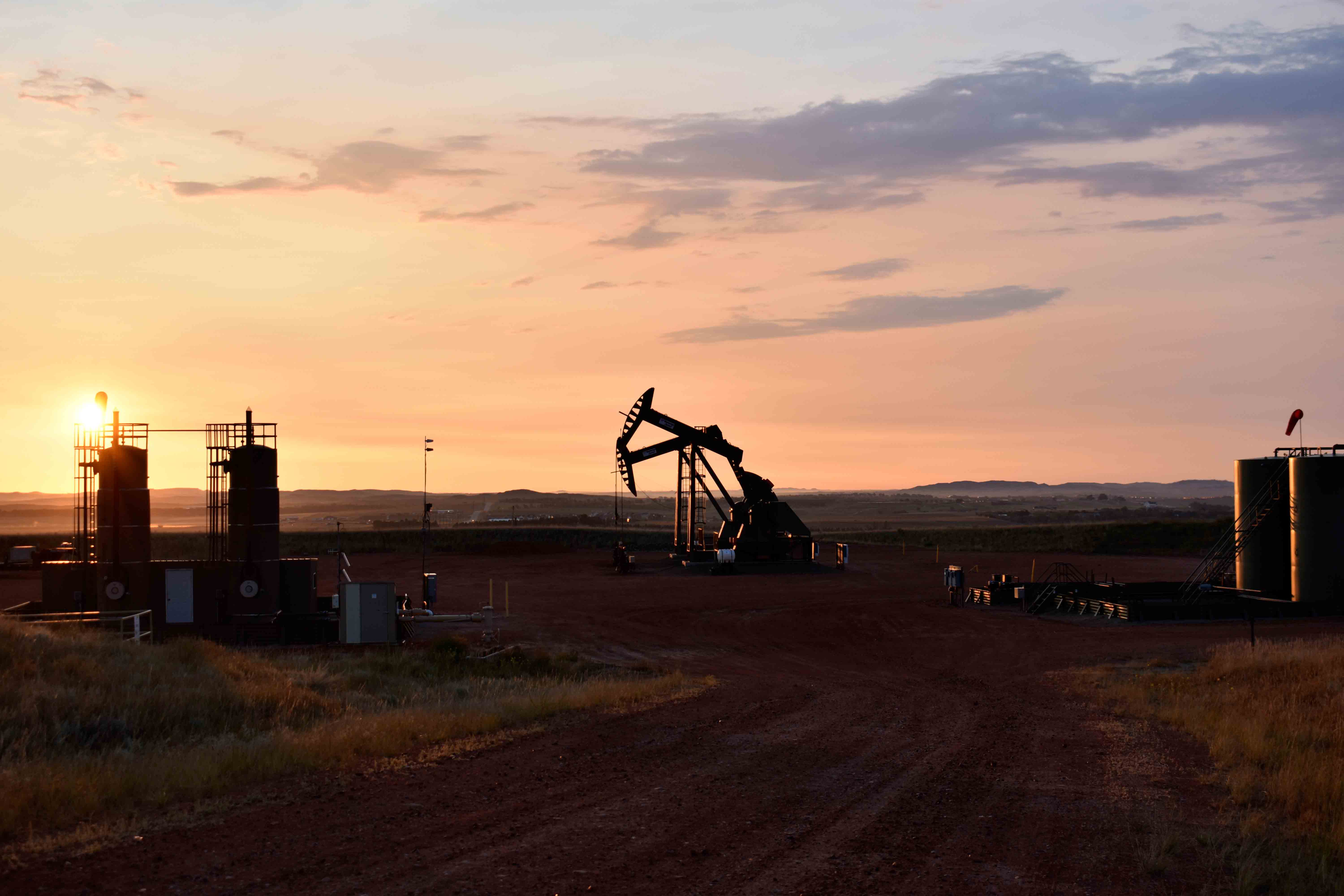 An oil well works at sunrise Aug. 25, 2021, in Watford City, N.D., part of McKenzie County.