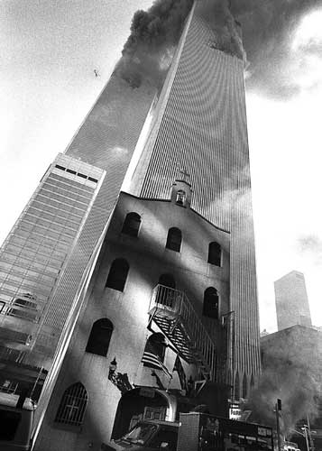 Sept. 11, 2001, photo provided by the Greek Orthodox Archdiocese of America, smoke billows from the World Trade Center towers as St. Nicholas Greek Orthodox Church sits below them in New York