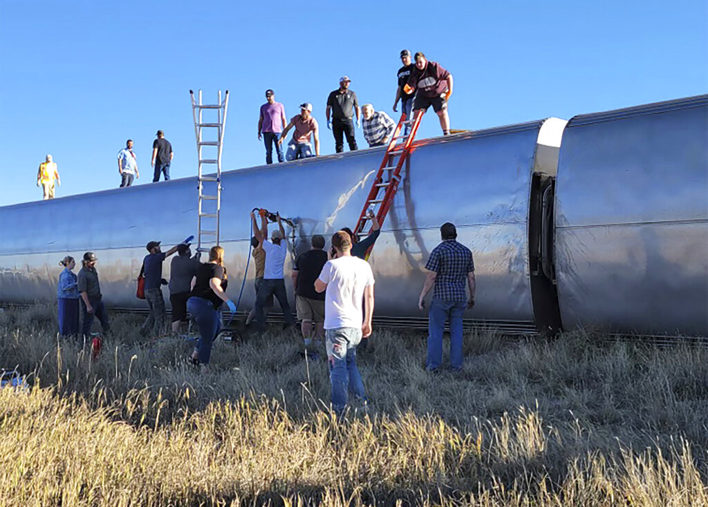 People work at the scene of an Amtrak train derailment