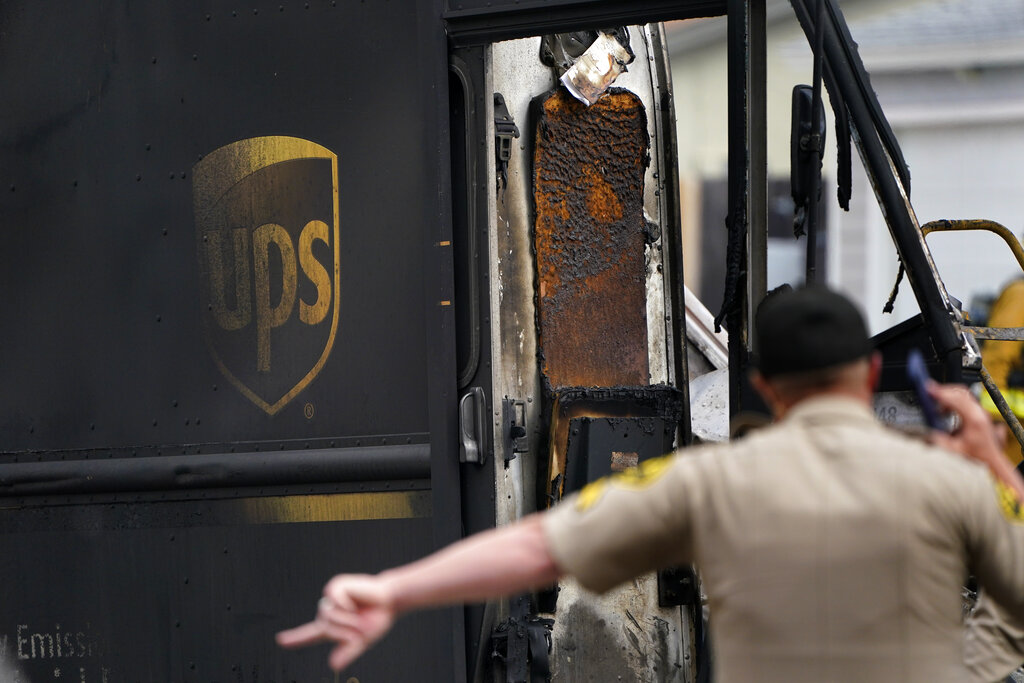 A burned truck sits at the scene of the plane crash