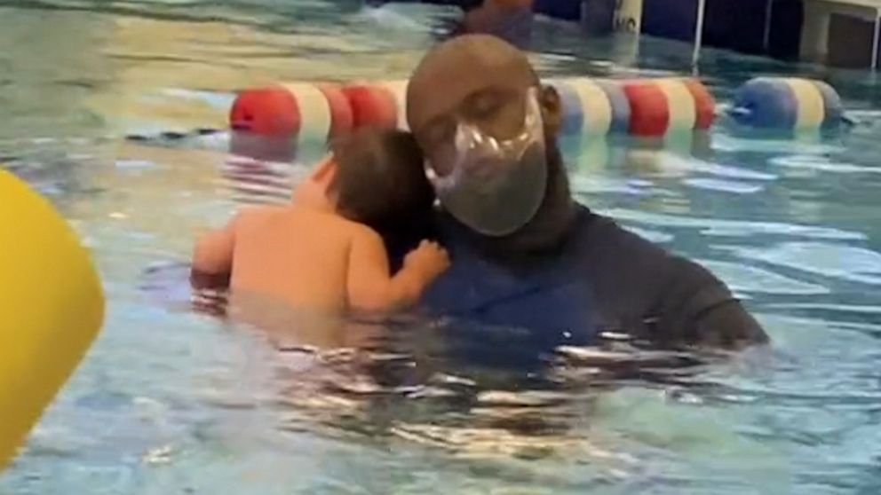 Baby and his swim lesson instructor