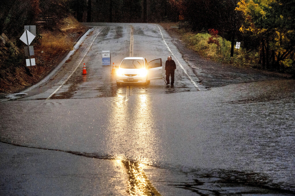 Motorist surveys floodwaters over roadway in Northern California 