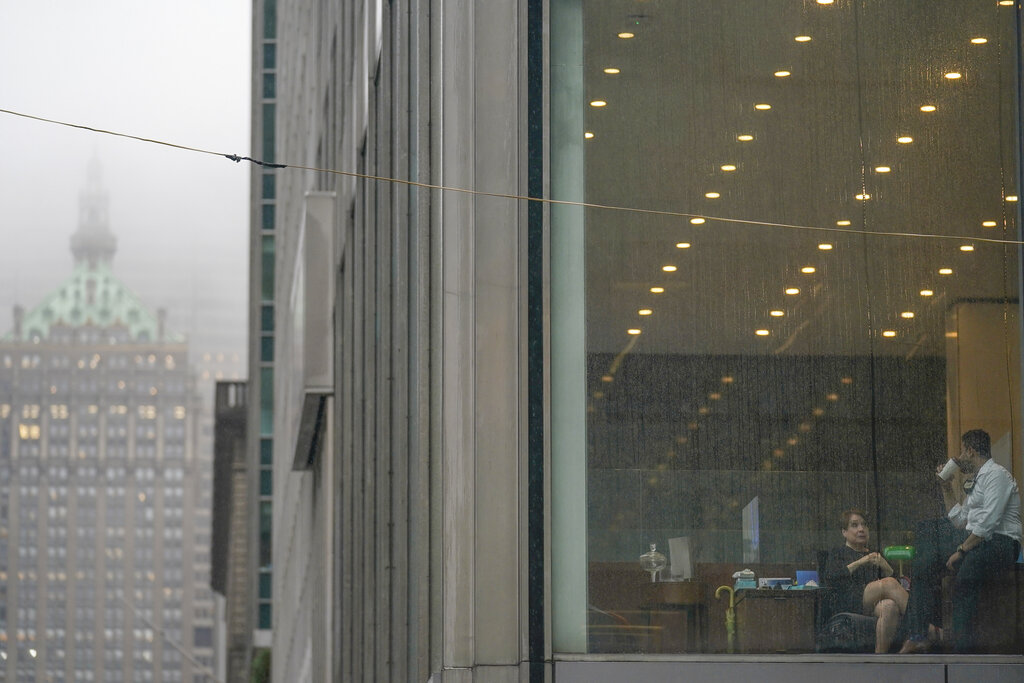 Rain runs down an office window on a rainy and foggy day in New York