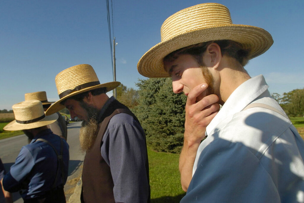 Amish men gather across the street from the one-room schoolhouse in Nickel Mines, Pa., after a fatal shooting at the school. An example of Anabaptist values is the response of the Amish community around Nickel Mines, after a gunman killed five Amish schoolgirls and wounded five more in 2006 before taking his own life. Local Amish immediately expressed forgiveness for the killer and supported his widow. “If we do not forgive, how can we expect to be forgiven?” the Amish leaders said in a statement.