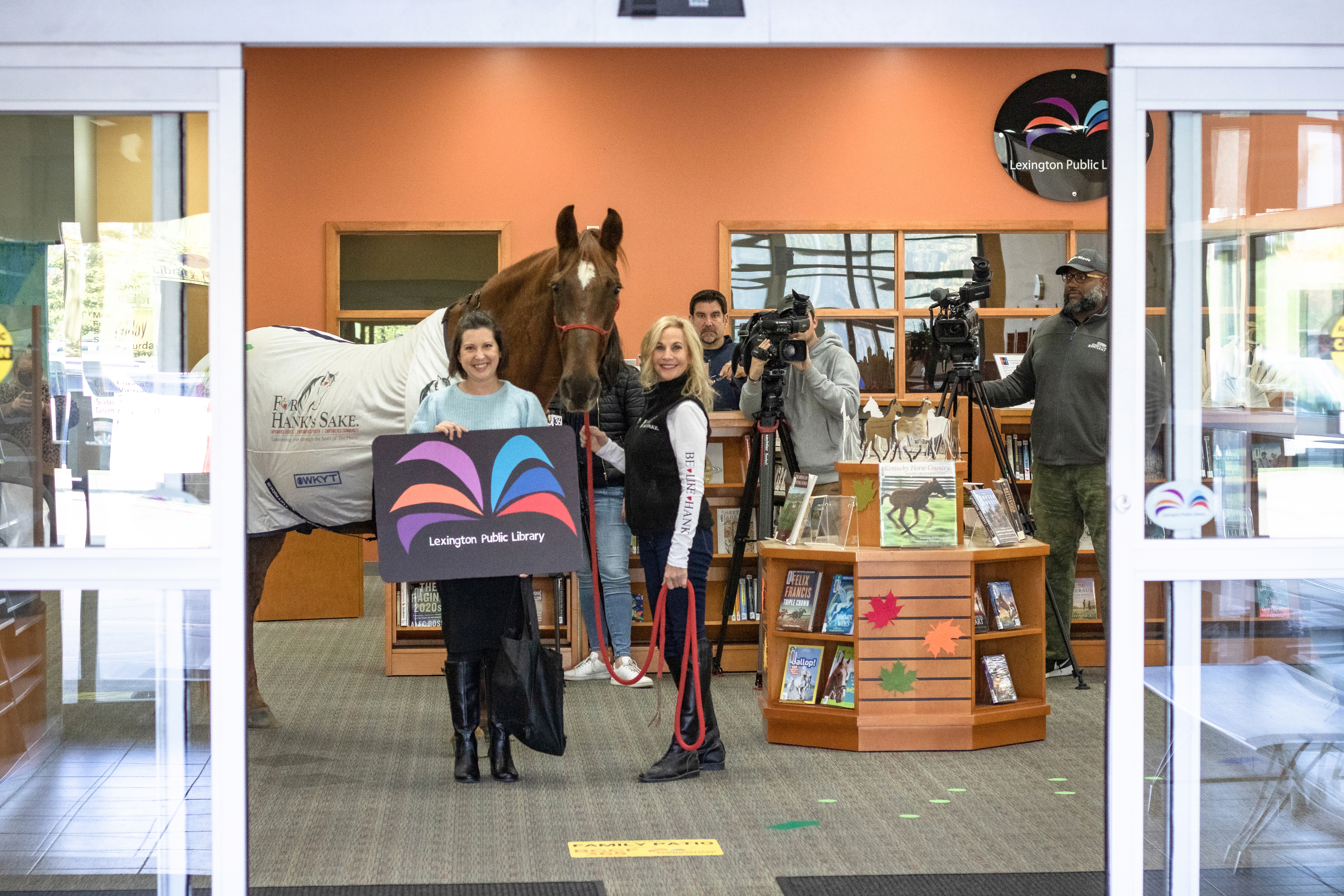 Hank inside the library with his horse-sized library card