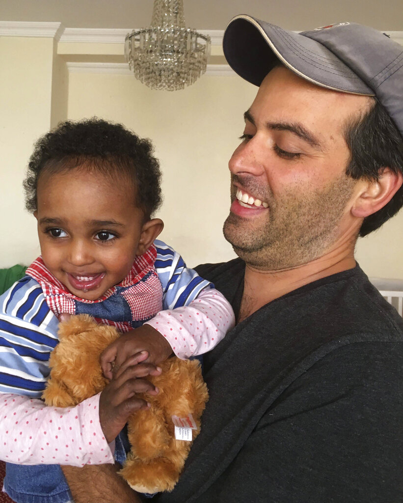 Naomi Pascal her dad Ben and teddy bear at an orphanage in Ethiopia