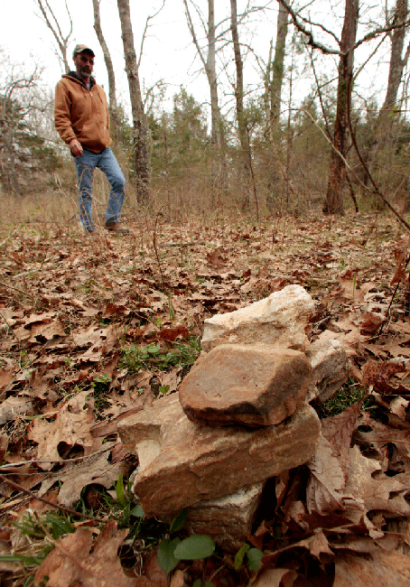 Andy Justice walks to a pile of rocks on land he farms about two miles east of Plato, Mo., on March 24, 2011. The rocks were placed there by a government survey crew to mark the population center of the United States according to the 2010 census.