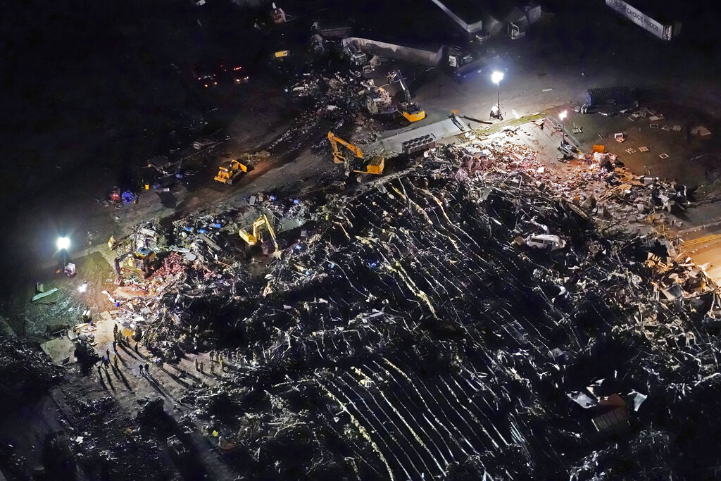 n this aerial photo, a collapsed factory is seen with workers searching for survivors in Mayfield, Ky.