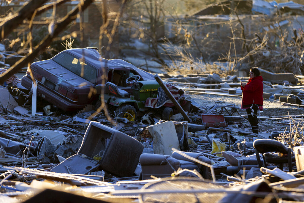Dena Ausdorn stands at the remains of her home after a tornado in Dawson Springs, Ky.