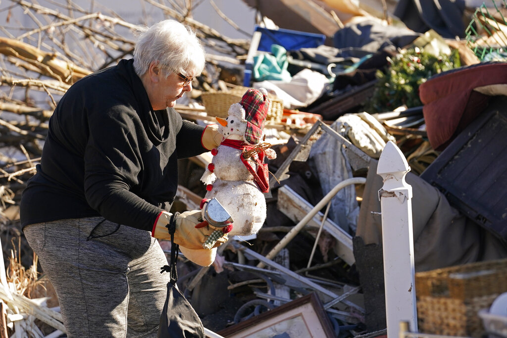 Martha Thomas salvages Christmas decorations from her destroyed home in the aftermath of tornadoes that tore through the region, in Mayfield, Ky., Monday, Dec. 13, 2021
