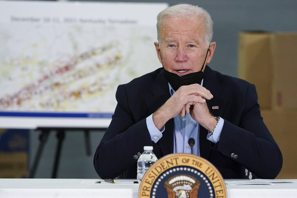President Joe Biden speaks as he attends a briefing from local leaders on the storm damage from tornadoes and extreme weather at Mayfield Graves County Airport in Mayfield, Ky.
