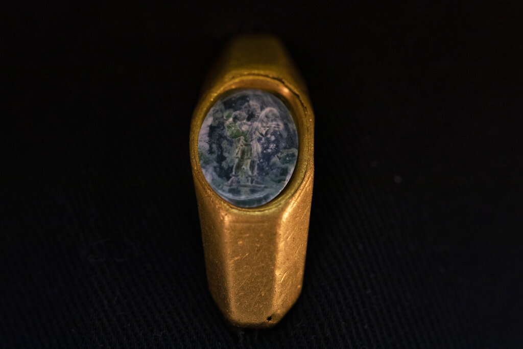 A Roman gold ring, its green gemstone carved with the figure of a shepherd carrying a sheep on his shoulders, dating to around 1,700 years ago, is displayed after it was found near the ancient city of Caesarea