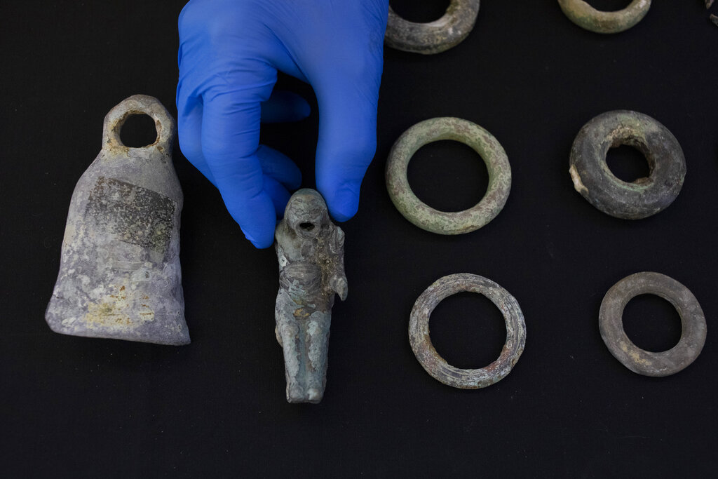 Jacob Sharvit, director of the Marine Archaeology Unit of the Israel Antiquities Authority holds the finds made near the ancient city of Caesarea , dated to the Roman and Mamluk periods, around 1,700 and 600 years ago