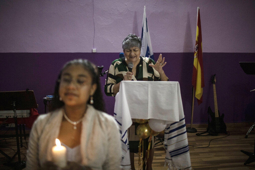 Argentinian Pentecostal Pastor Nedyt Lescano, 62, leads a rite of passage ceremony for Melanie Villalobos Enriquez, from Venezuela