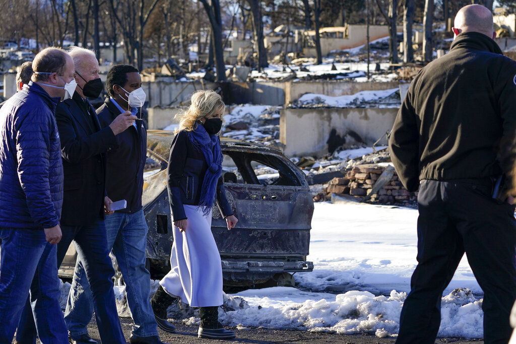 President Joe Biden and first lady Jill Biden tour a neighborhood in Louisville, Colo.