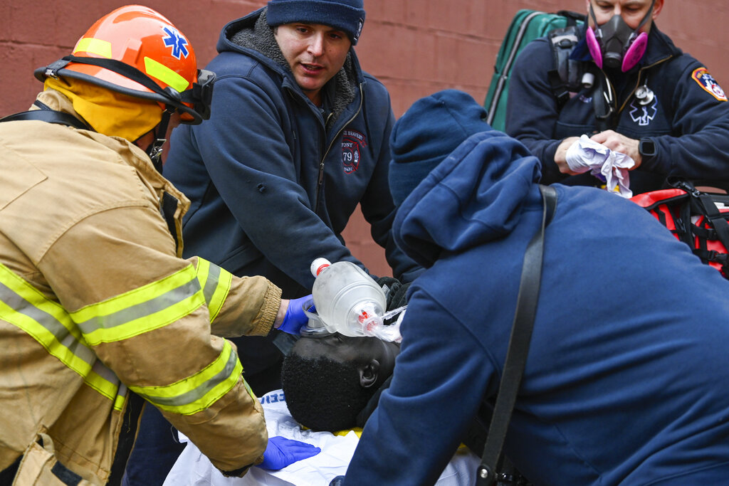 Emergency personnel perform CPR on a fire victim during a high rise fire on East 181 Street