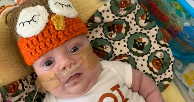 Baby in crocheted hat that looks like an owl