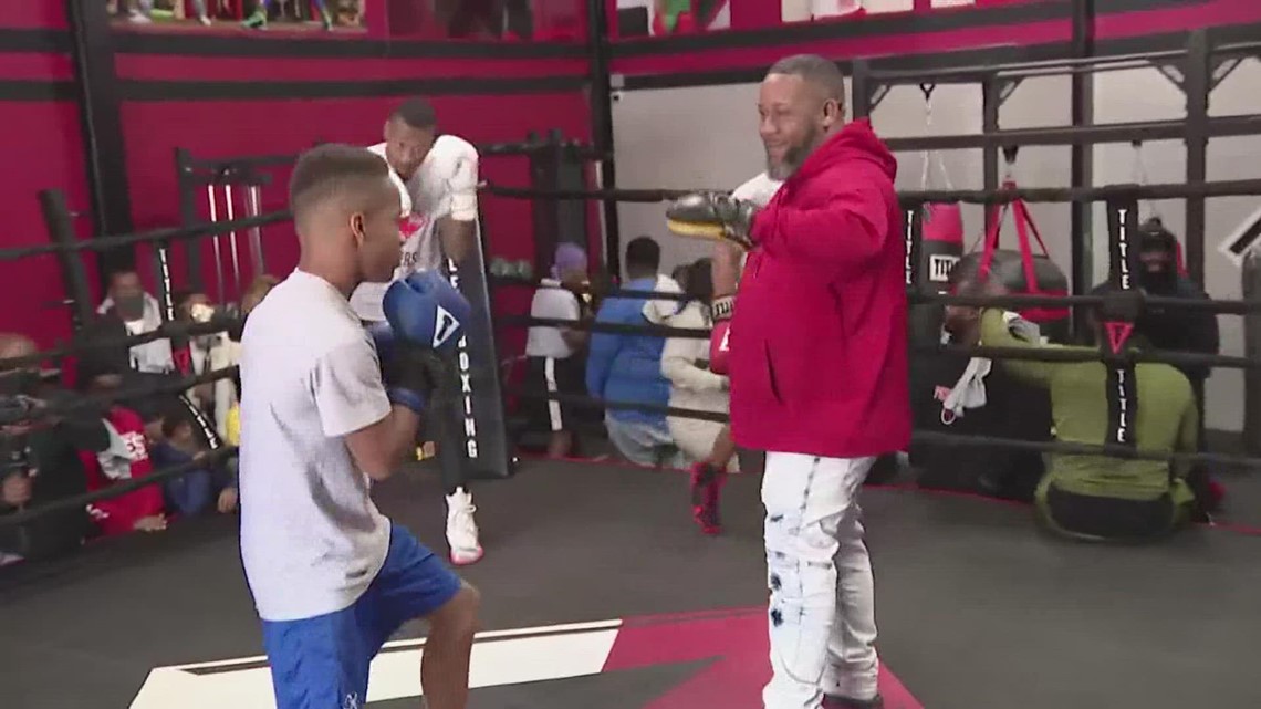 kid and trainer in boxing ring