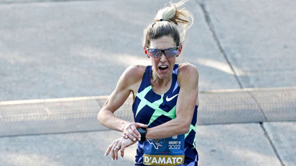Marathon runner with blond ponytail and tank top