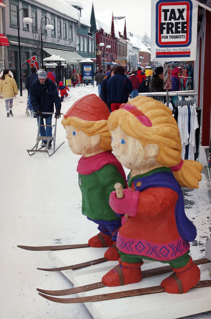 The wooden mascots of the Winter Olympics watch over one of the main shopping streets on Feb. 8, 1994, in Lillehammer, Norway