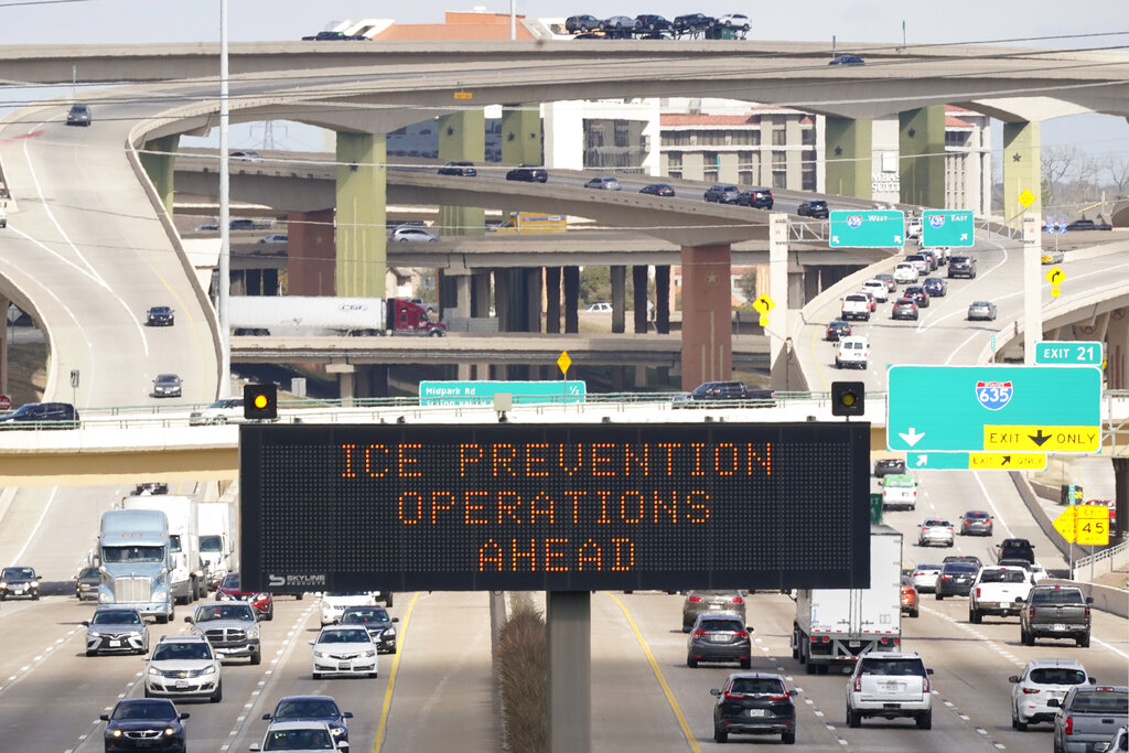 Street sign warns drivers of ice prevention operations on highways ahead of winter weather