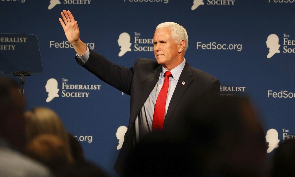 Former Vice President Mike Pence waves to attendees at the Florida chapter of the Federalist Society