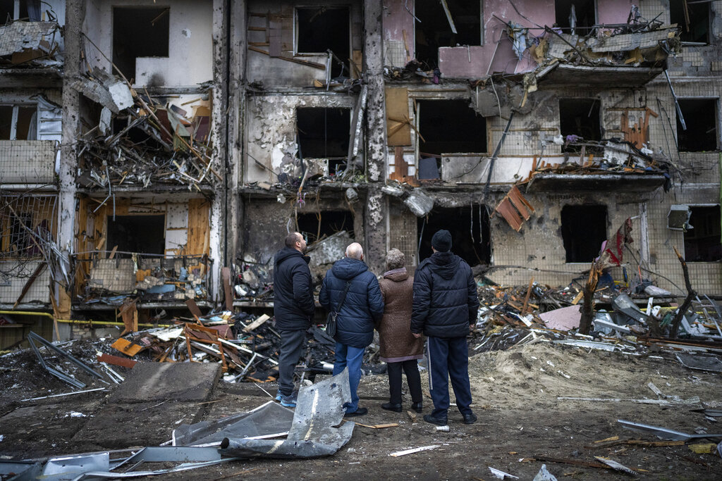 People look at damage after rocket attack in Kyiv, Ukraine