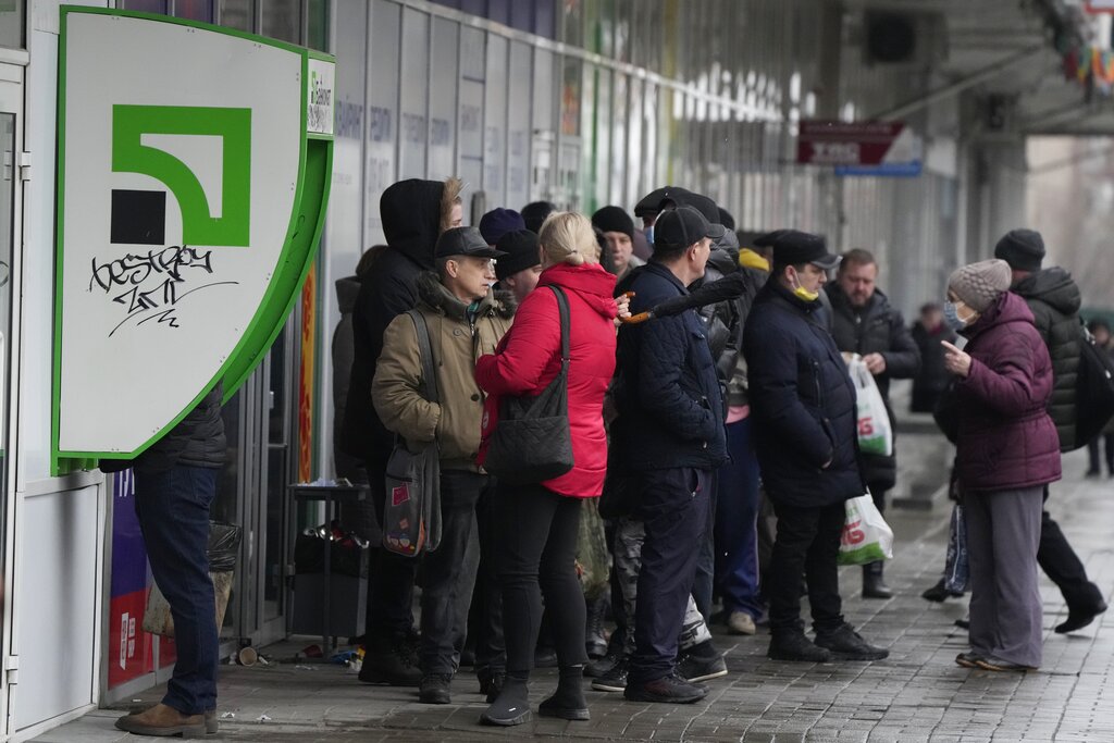 People waiting to withdraw money at ATM in Ukraine