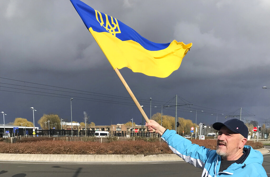 A protestor waves a Ukrainian flag as he takes part in a demonstration outside a NATO leaders virtual summit at NATO headquarters in Brussels