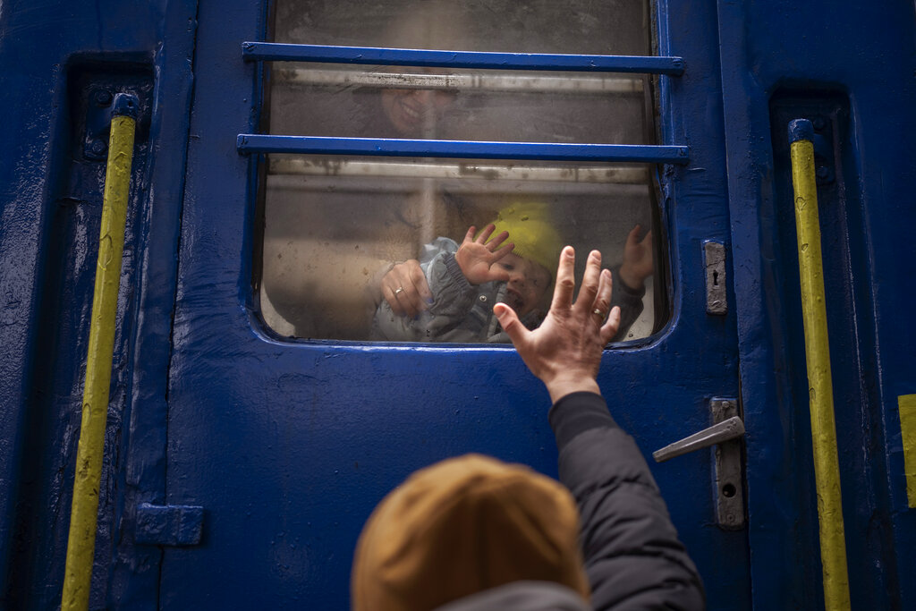 Man waves goodbye to son and wife at Kyiv train station 