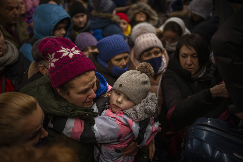 Women and children try to board train in Kyiv
